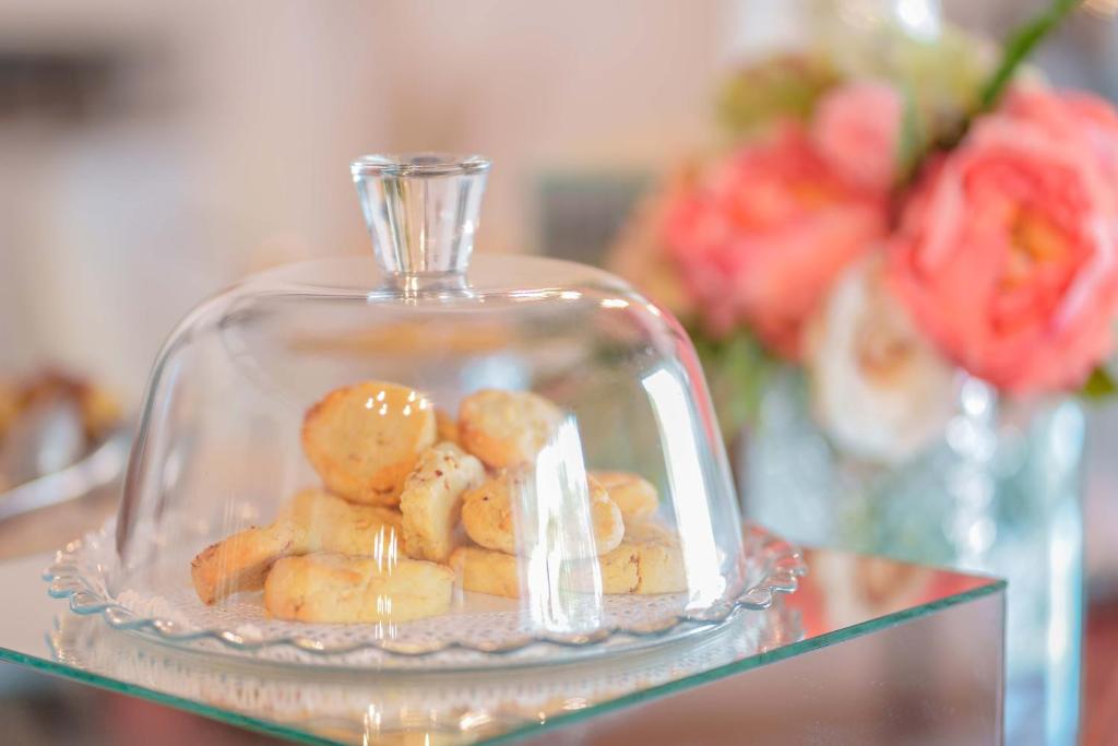 a glass container filled with cookies on a glass table at Il Monastero in Geremèas