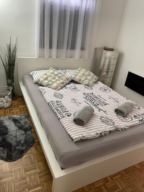 a bed with two pillows on it in a bedroom at Hiška Orel Terme Čatež in Čatež ob Savi