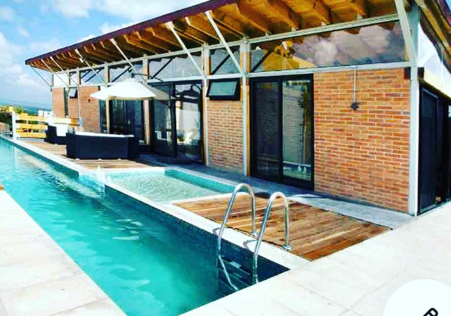 a house with a swimming pool next to a building at Casa Morales - San Miguel de Allende - Private Heated Pool and Wi-Fi in San Miguel de Allende