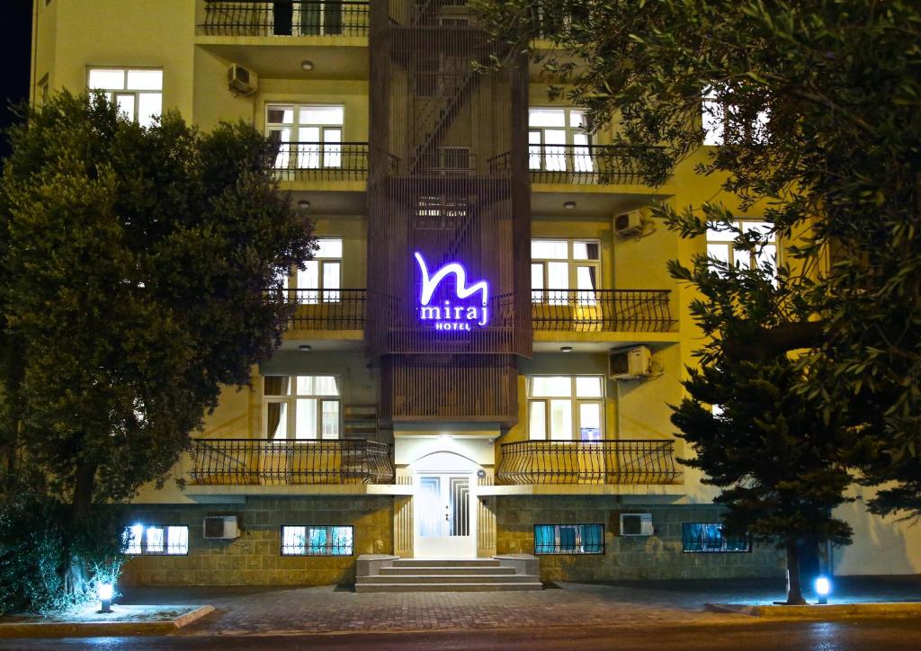 a building with a purple sign on the side of it at Miraj hotel in Baku