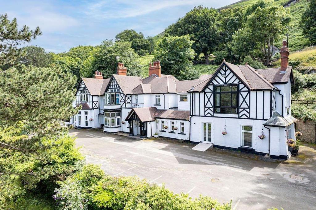 an aerial view of a house with a driveway at Delightful holiday home with sea views and Hot Tub in Penmaen-mawr