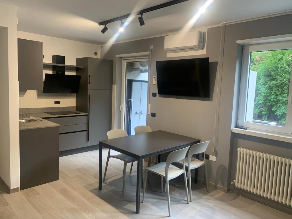 a kitchen and dining room with a table and chairs at Rivacentro 2 in Riva del Garda