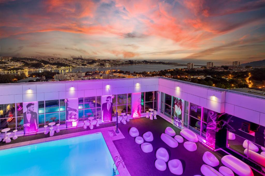 a house with a swimming pool and purple lighting at HF Ipanema Park in Porto
