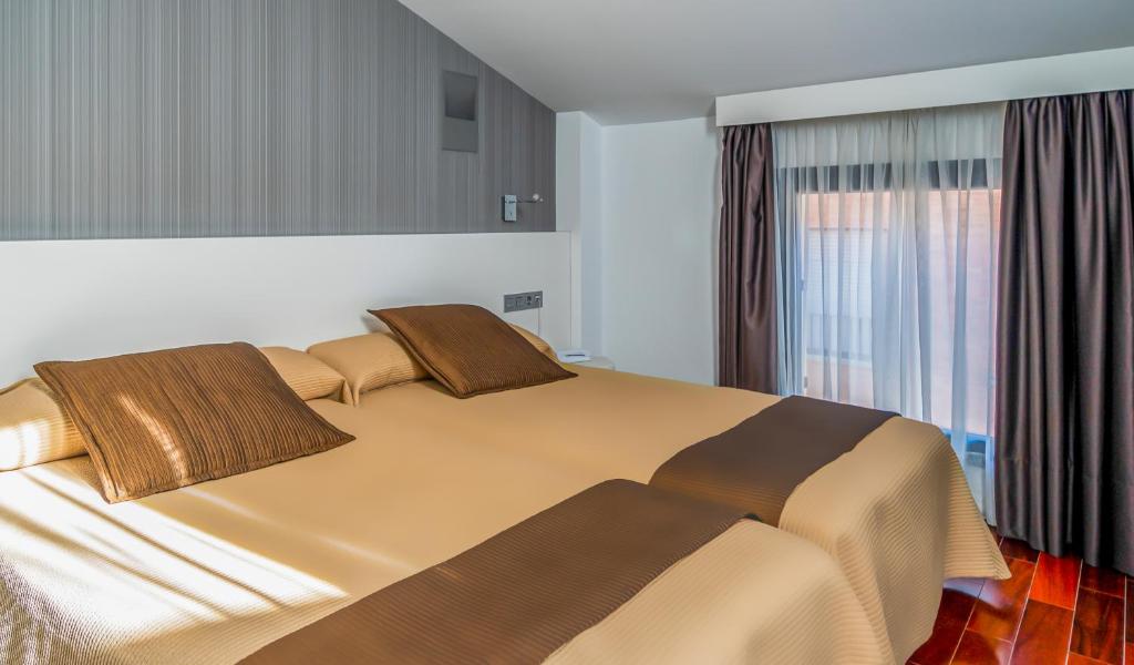 Postel nebo postele na pokoji v ubytování Hotel Apolonia Soria