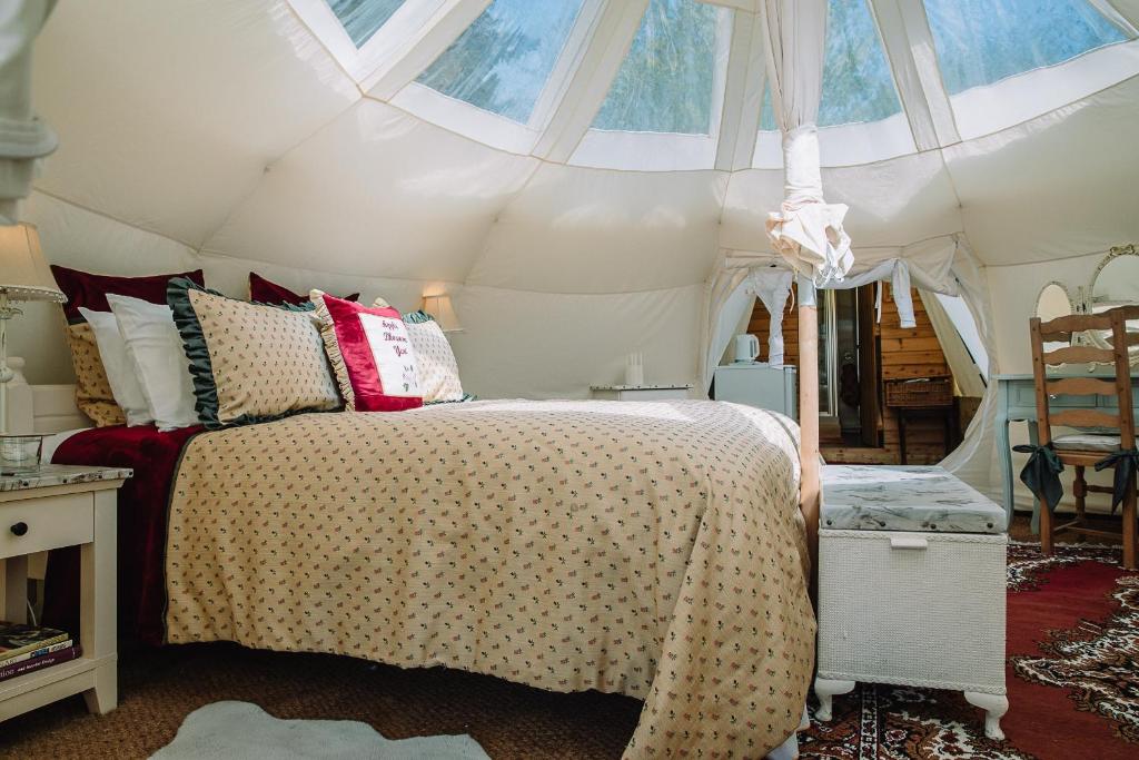 a bedroom with a bed in a tent at Appleblossom Yurt in Alkborough