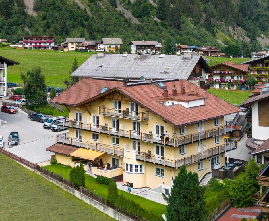 an aerial view of a large yellow building at Appartements zur Sonne in Neustift im Stubaital