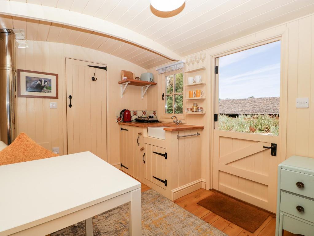 a kitchen with a counter and a window at The Hut in Nymphsfield