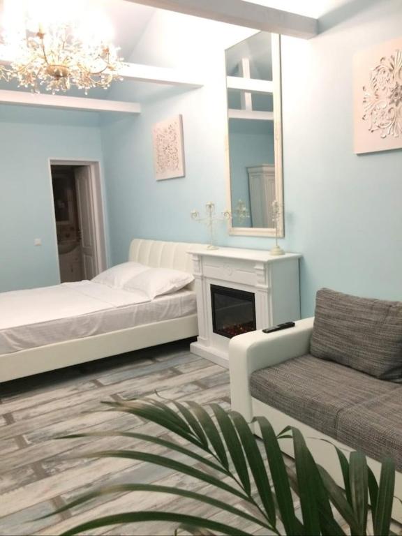a bedroom with a bed and a chair and a mirror at Solaria House in Constanţa