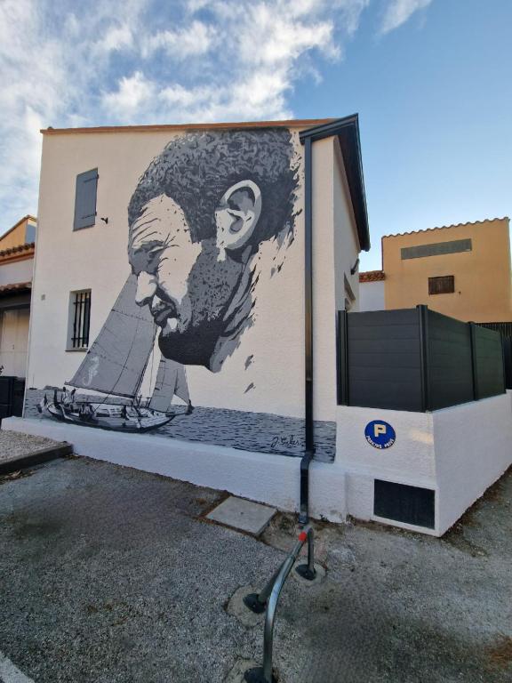 un bâtiment avec une grande fresque murale sur son côté dans l'établissement Le Navigateur - Canetoise refaite à neuf, à Canet