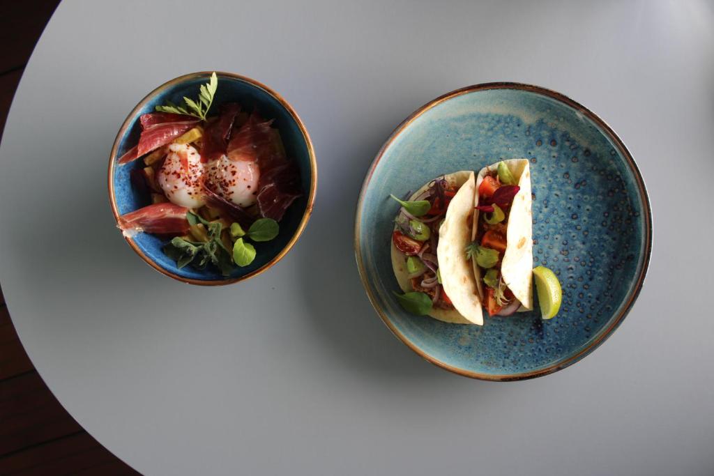 two bowls of food on a white table at InterContinental Cascais-Estoril by IHG in Estoril