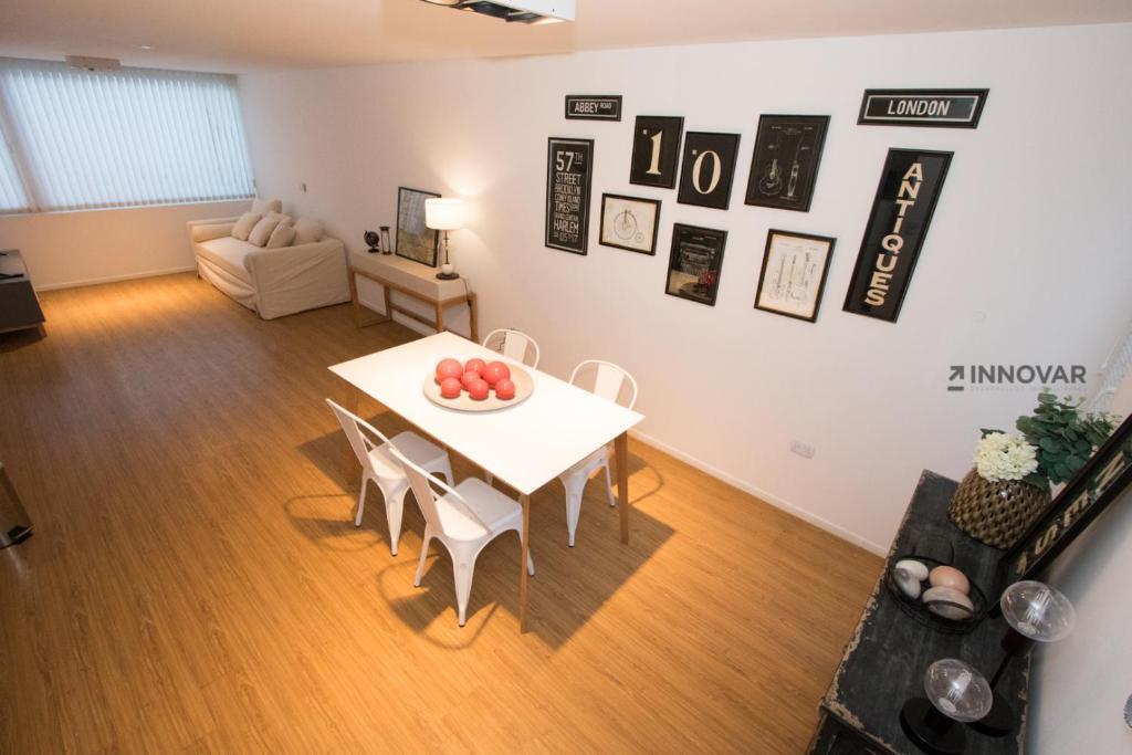 a living room with a white table and chairs at Gray Fox Apartments Deloqui in Ushuaia