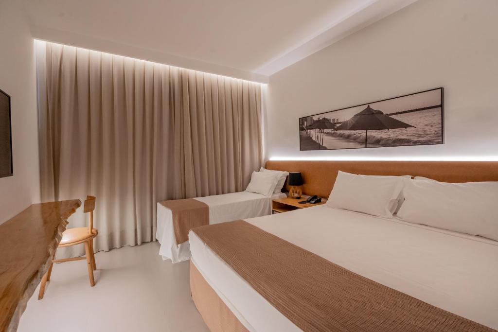 Postel nebo postele na pokoji v ubytování Pauli Boutique Hotel