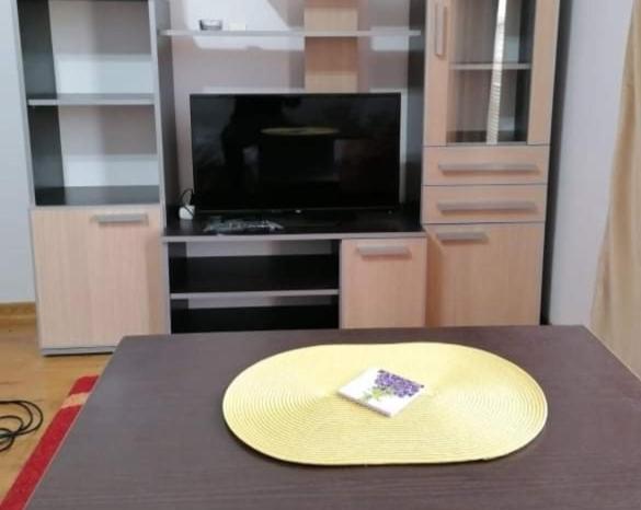 a yellow hat sitting on a table in a kitchen at Apartman Elena in Vrnjačka Banja