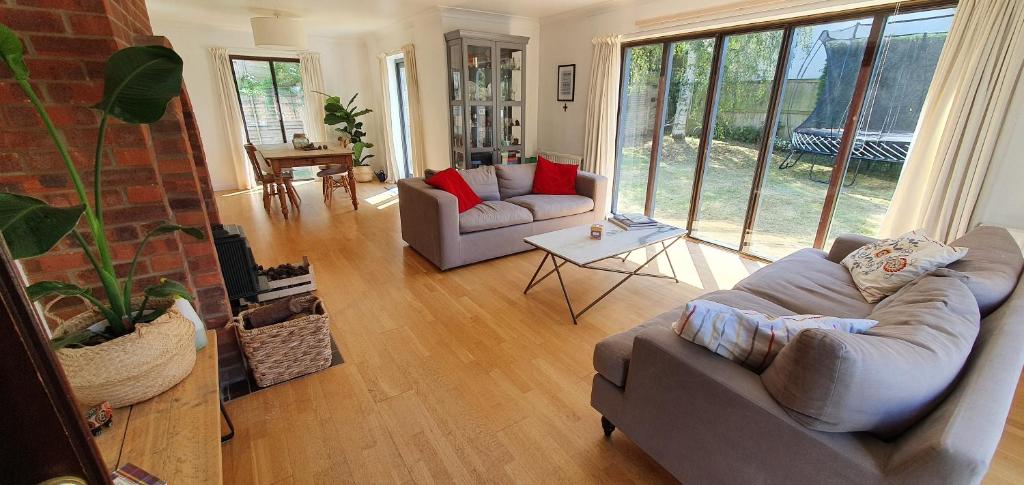 a living room with two couches and a table at Island Retreat in West Mersea