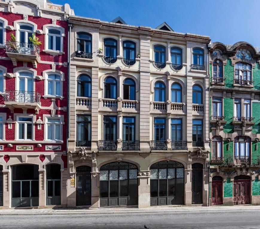 a large building with a clock on the side of it at BO - Bolhão Apartments in Porto