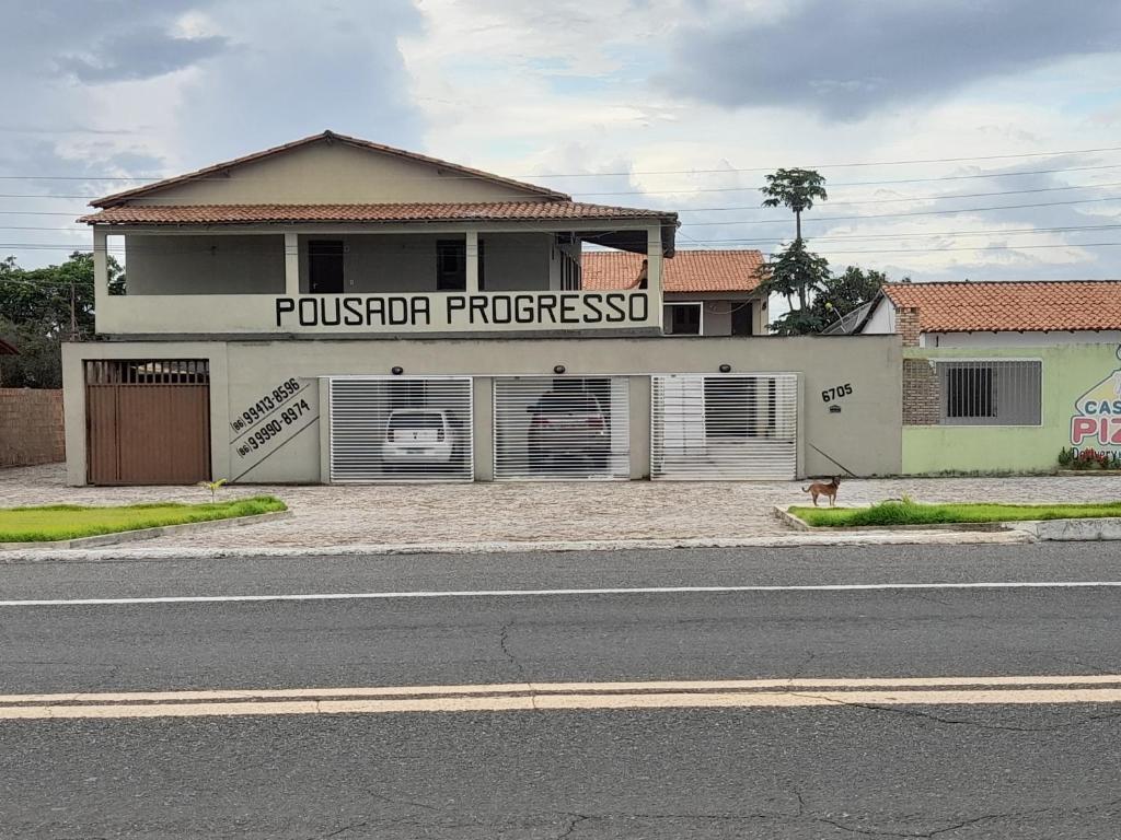 a building with two garage doors on a street at Pousada Progresso in Parnaíba