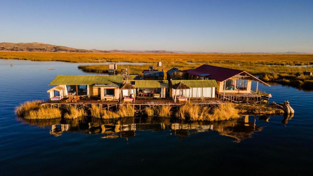 an island in the middle of a body of water at UROS TITICACA LODGE Puno Peru in Puno