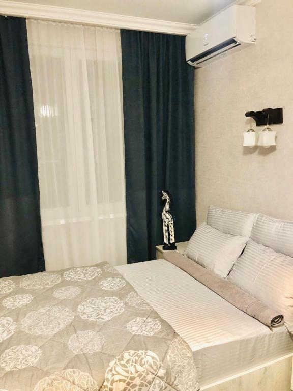 a bedroom with a bed with a bird on it at Apartment Mari in Tbilisi City