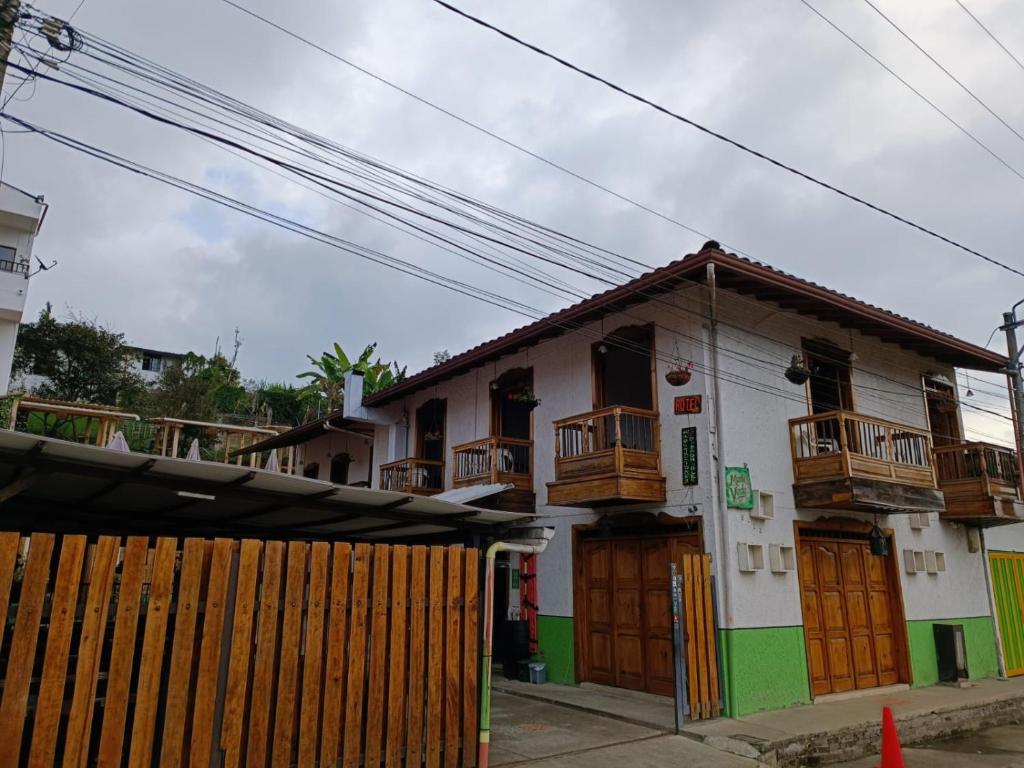 a house with wooden doors and a fence at Hotel Monte verde in Salento