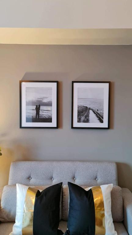 two framed pictures on a wall above a couch at The Nook at Serin Tagaytay in Tagaytay