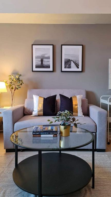 a living room with a couch and a glass table at The Nook at Serin Tagaytay in Tagaytay