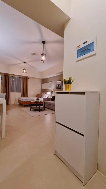 a living room with a kitchen and a living room with a couch at The Nook at Serin Tagaytay in Tagaytay