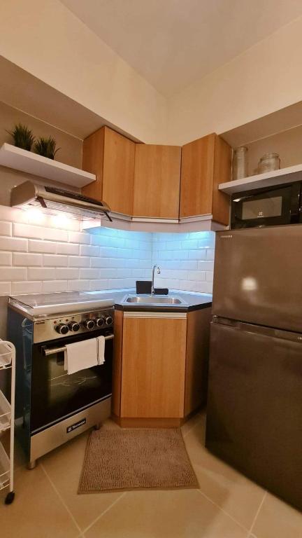 a kitchen with a stove and a sink at The Nook at Serin Tagaytay in Tagaytay