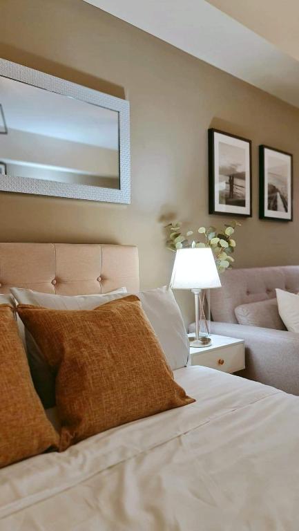 a bedroom with a large bed and a couch at The Nook at Serin Tagaytay in Tagaytay