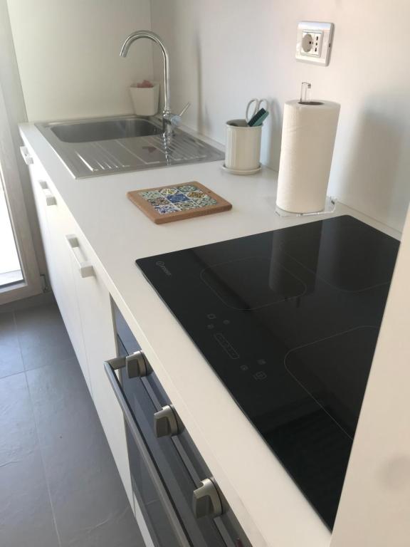 a kitchen with a sink and a counter top at SeSil Amare in Porto Recanati