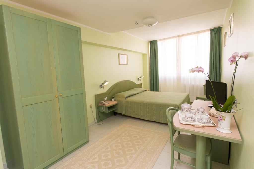 Postel nebo postele na pokoji v ubytování Hotel Grillo