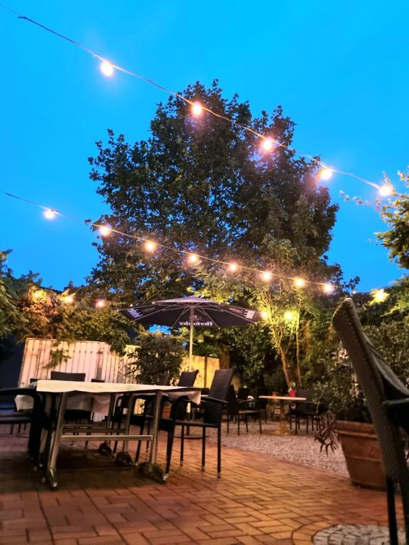 a patio with tables and lights at night at Hotel Altes Gasthaus Düsterbeck in Emsdetten