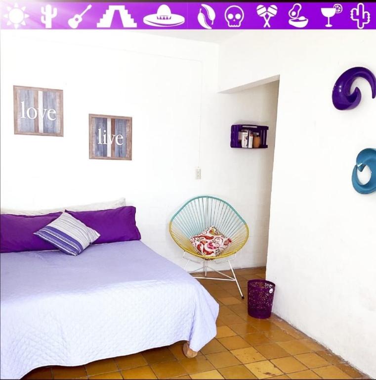 Postel nebo postele na pokoji v ubytování Hostal Casa Colores Adults Only