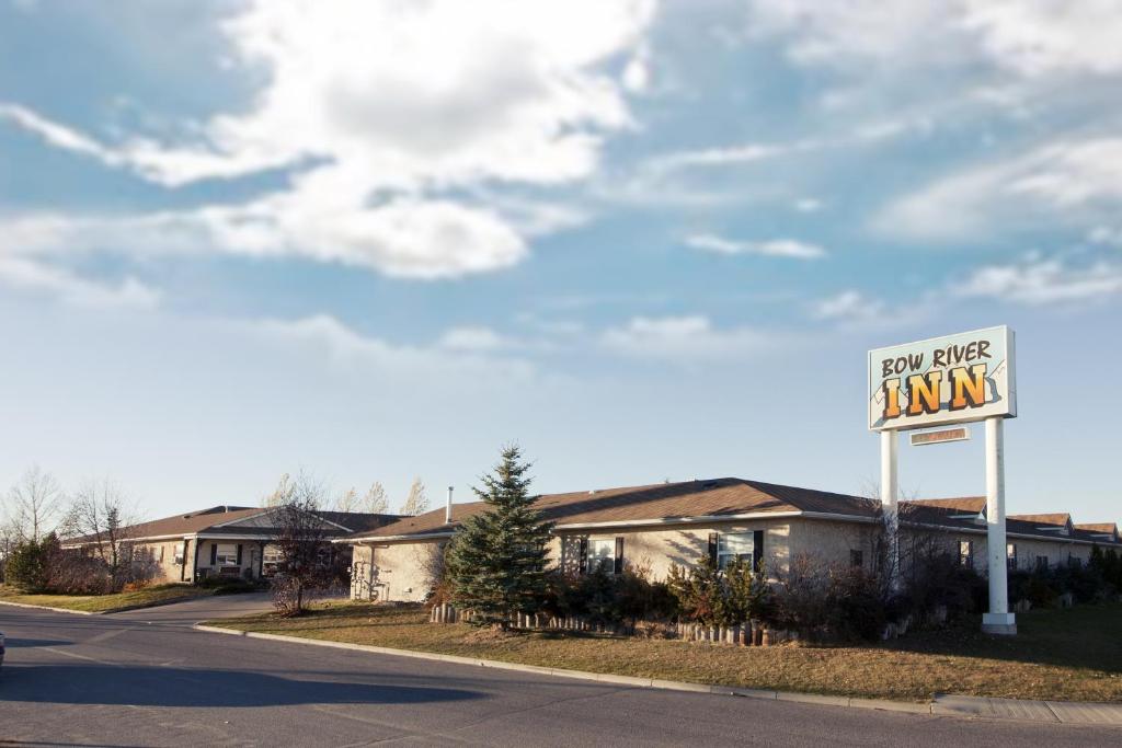 a motel sign on the side of a road at Bow River Inn in Cochrane