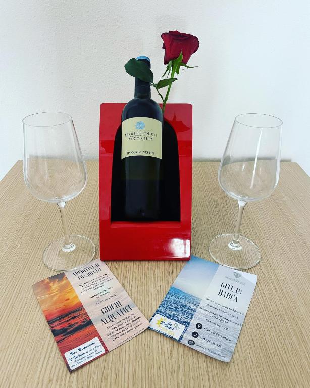 a bottle of wine and two wine glasses on a table at Luxury Tugurio in Arma di Taggia