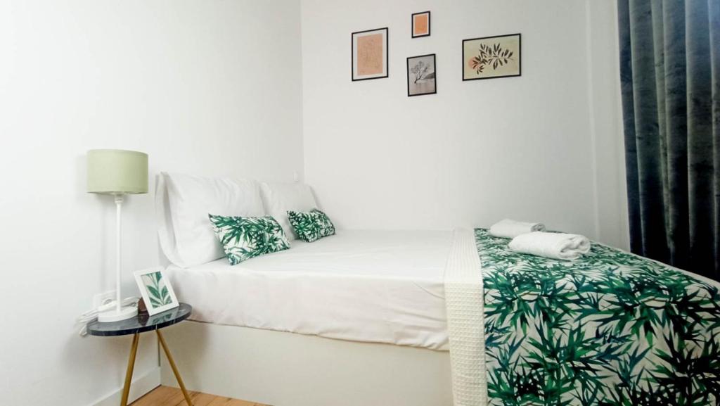 - une chambre dotée d'un lit avec des draps verts et blancs dans l'établissement DOWN TOWN Luxurious Apartments (4), à Alexandroúpolis