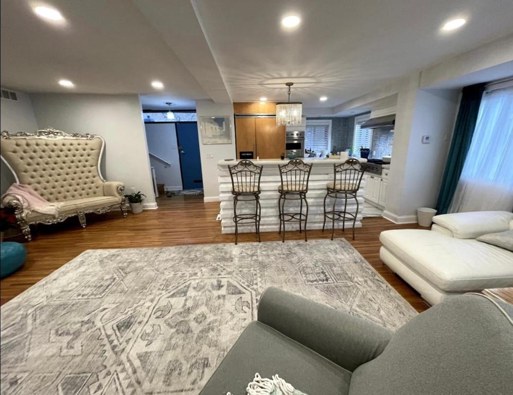 a living room with a couch and a kitchen at A Regal Retreat- Exclusive Parking, Prime Location in Philadelphia