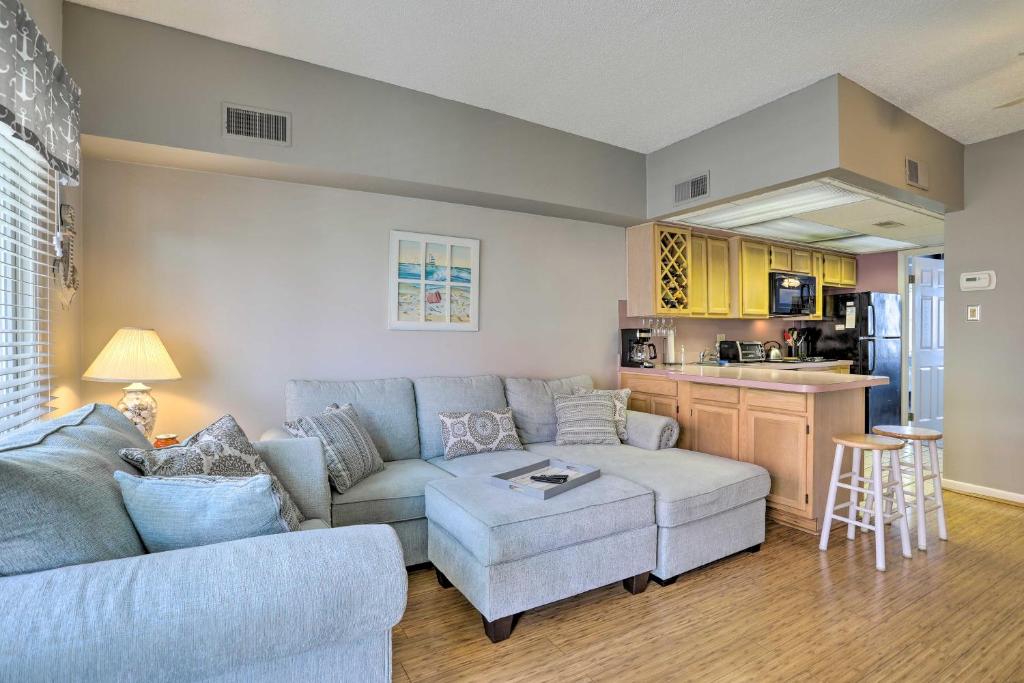a living room with a couch and a kitchen at Quaint Wildwood Condo about Walk to Beach! in Wildwood
