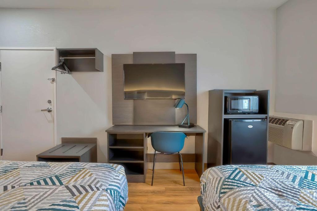 a small room with a kitchen with a bed and a desk at Motel 6-Denison, TX in Denison