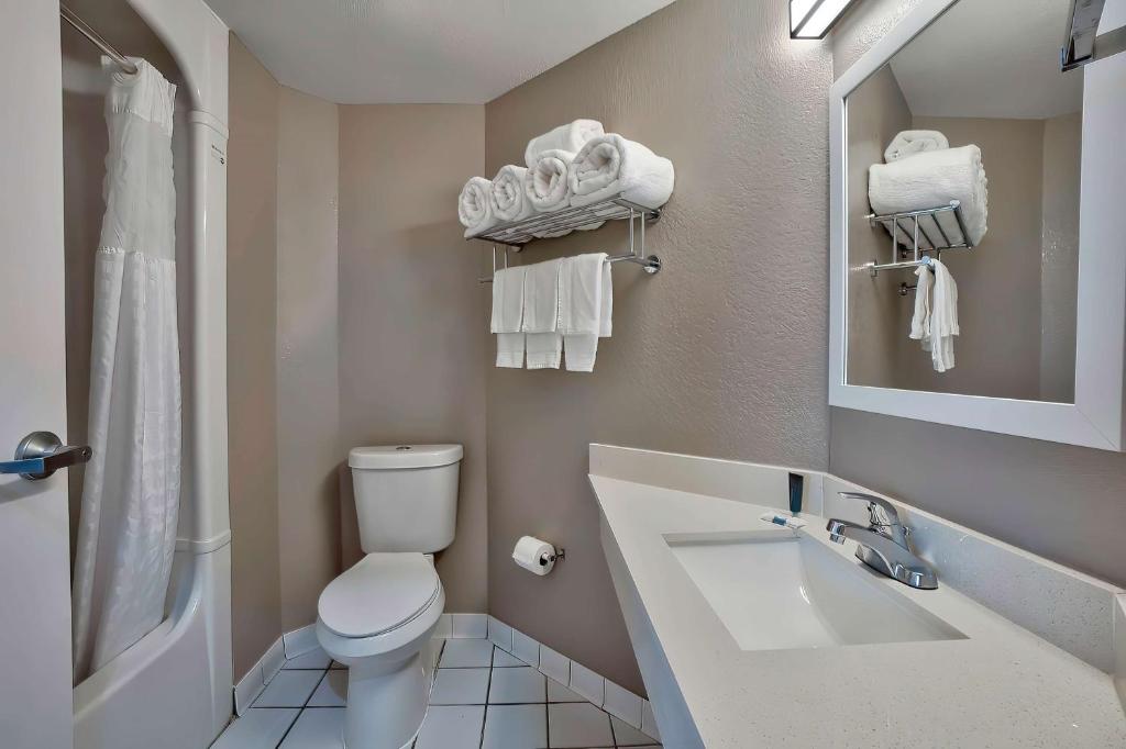 a bathroom with a white toilet and a sink at Motel 6-Denison, TX in Denison