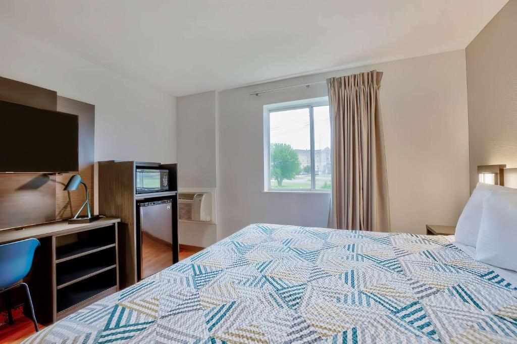 a hotel room with a bed and a window at Motel 6-Denison, TX in Denison