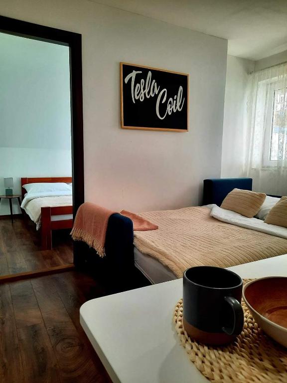 a room with two beds and a sign on the wall at Tesla Coil Apartments in Gospić