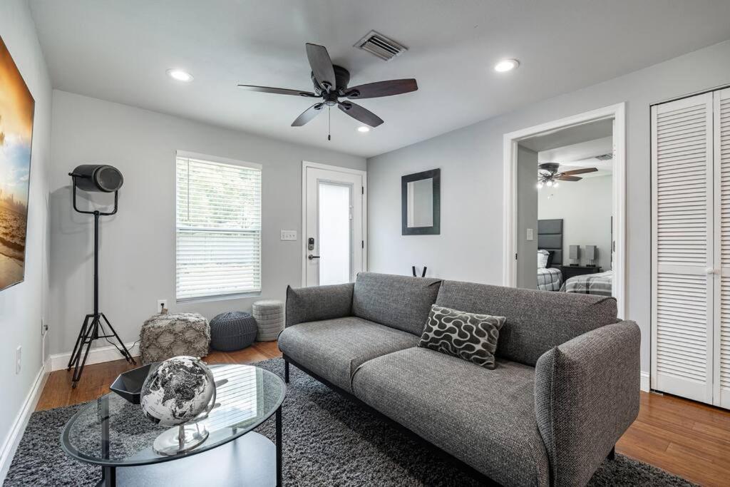 a living room with a couch and a ceiling fan at Grand Oaks Terminal in the Heights in Tampa