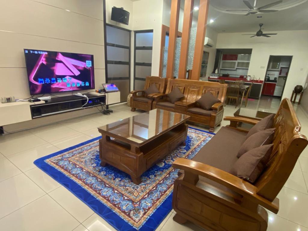 a living room with couches and a flat screen tv at Villa near SPICE Arena 8BR 45PAX V KTV Pool Table and Kids Swimming Pool in Bayan Lepas