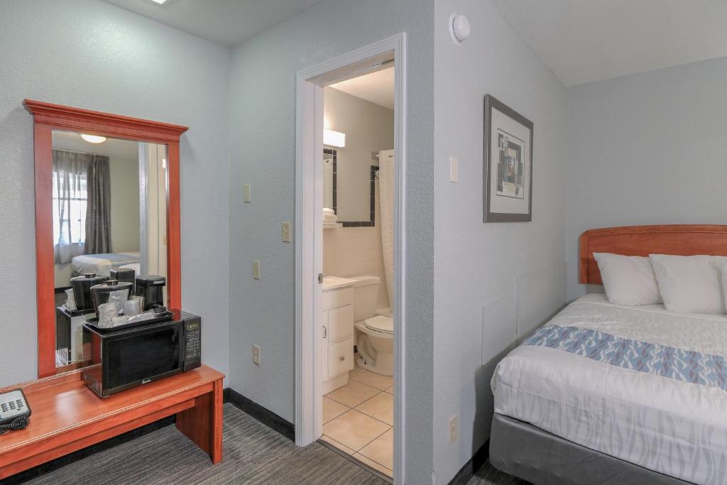 a hotel room with a bed and a bathroom at Belle Aire Motel - Downtown Convention Center - Gatlinburg in Gatlinburg