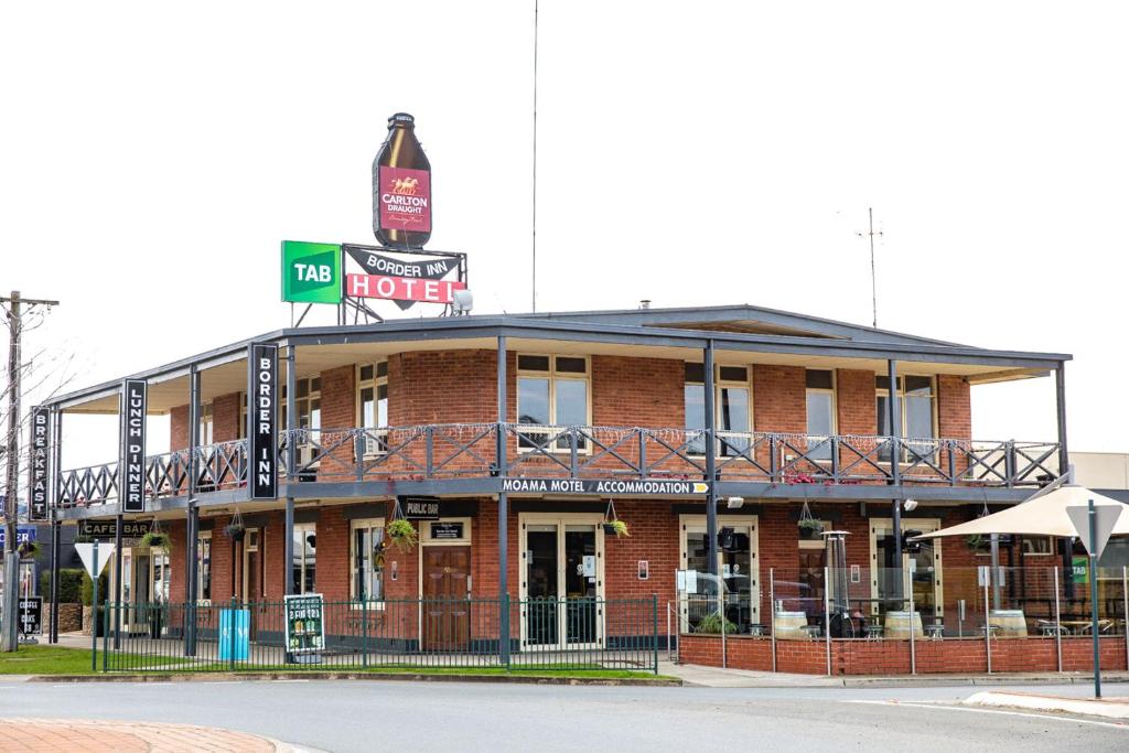 a large building with a sign on the side of it at Moama Motel in Moama