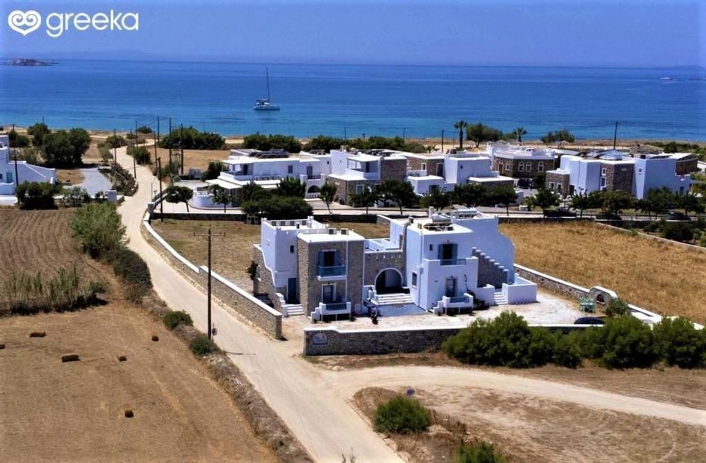 z powietrza widok na ośrodek z oceanem w obiekcie Blue Harmony Apartments w mieście Plaka