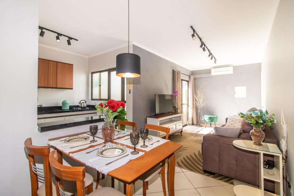 uma cozinha e sala de estar com mesa e cadeiras em Apartamento Moderno com Terraço à 4Km do Consulado USA em Porto Alegre