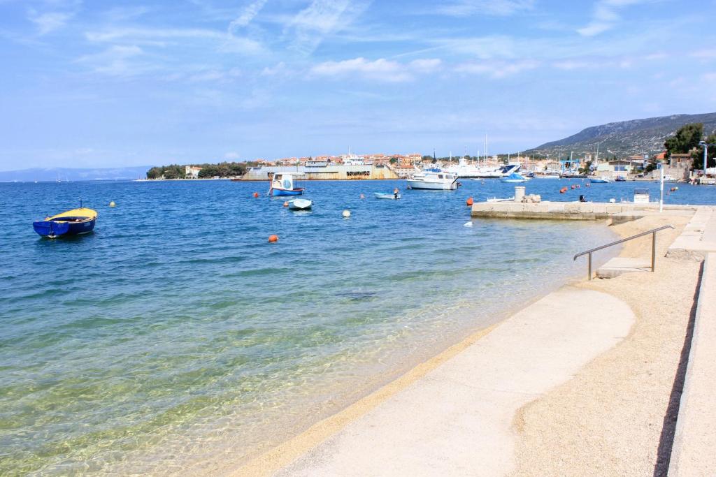 a beach with boats in a body of water at Apartments by the sea Cres - 8095 in Cres