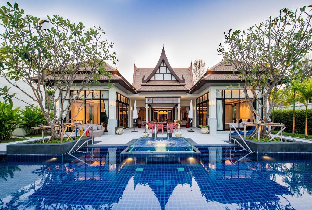 an exterior view of a house with a swimming pool at Laguna Pool Villas in Bang Tao Beach