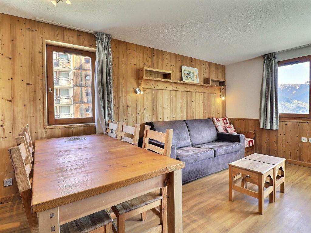 a living room with a table and a couch at Appartement La Tania, 2 pièces, 6 personnes - FR-1-182A-4 in Courchevel